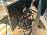 two computer monitors sitting on top of a wooden desk