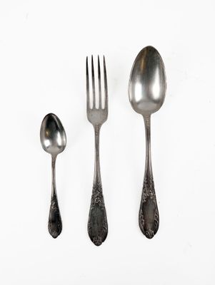 three spoons, a fork, and a spoon on a white surface