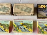 four boxed boxes of toys are lined up on a table