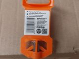 a small orange tool on top of a cardboard box