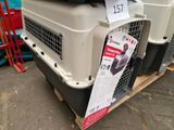 a dog crate with a dog in it on a pallet
