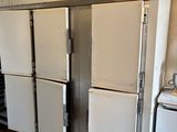 several refrigerators are lined up in a kitchen with tile flooring