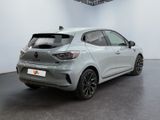 the rear of a silver car in a white room