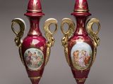 pair of red and gold vases with pictures of people on them