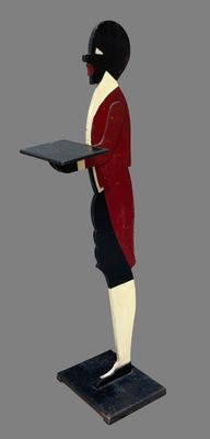 a figurine of a man holding a tray in his hand