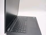 a laptop with a black keyboard sitting on a white surface