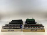 three model trains are sitting on display on a white surface