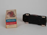 a small black toy car next to a box of cigarettes