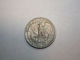an image of a silver coin on a white surface