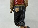 figurine of a man in a red vest and black skirt