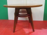 a wooden table with a red floor and a green wall
