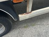 a flat bed trailer with a flat bed on the side of the road