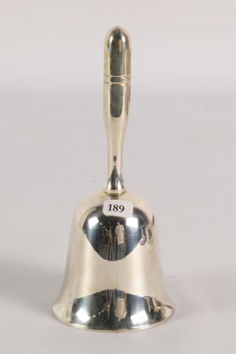 silver plated bell with the word go on it sitting on a white surface