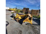 a yellow tractor with a loader sitting on top of it