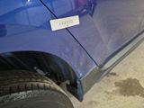 a close up of a blue car with a sticker on it