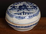 a small blue and white bowl on a wooden table