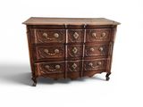 an antique chest of drawers with a wooden top and brass handles