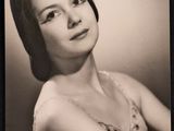 an old black and white photo of a woman in a dress