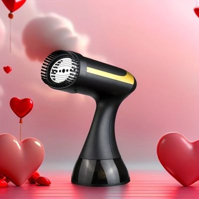 a black hair dryer sitting on top of a table next to hearts