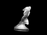 black and white photograph of a statue of a woman on a black background