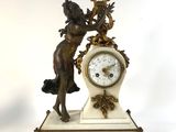 a statue of a woman holding a clock on a table