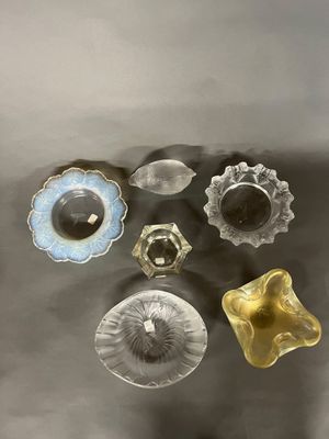 cinq boutons en verre de couleurs différentes posés sur une table