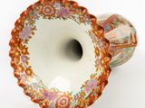 a vase that is sitting on a white surface