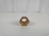 a brass plated nut on a white background