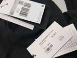 some black pants with price tags on them sitting on a table