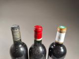 three bottles of wine sitting next to each other on a table