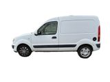 the white van is parked on the side of the road