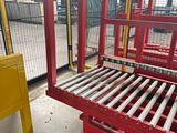 a picture of a red metal bed in a warehouse