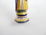 a figurine of a woman holding a basket of flowers