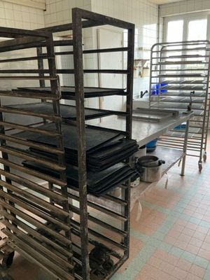 many racks of food that are on the floor in the kitchen