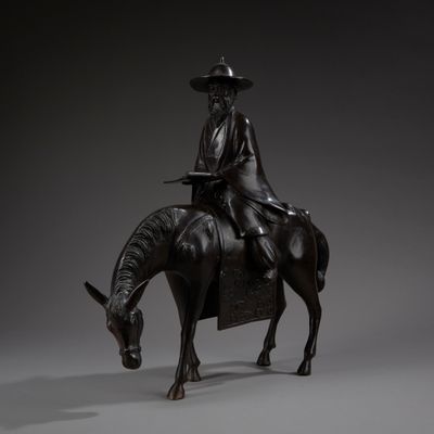 JAPON. Statuette de Toba sur sa mule en bronze à patine brun…