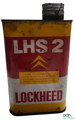 a yellow and red tin with a black lid