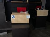 two desks in a room with a television on the wall