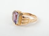 a gold ring with an amethorate and diamonds