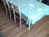 a table and chairs in a room with a blue table cloth on it
