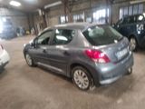 a silver car parked in a garage with other cars