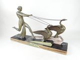 statue of a woman pulling a duck with a plow on a marble base