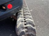 a tire tread on the ground next to a car