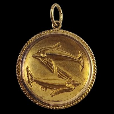a close up of a gold coin with a bird on it