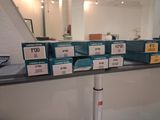 many boxes of cigarettes on a shelf in a room