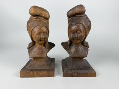 pair of wooden busturines of a woman and a man