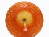 an apple that is sitting on a plate on a table