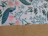 two peacocks sitting on top of a paper bag
