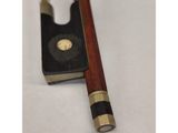 a close up of a violin bow on a white surface