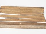 several pieces of wood are arranged on a white surface