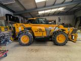 a large yellow construction vehicle parked in a warehouse
